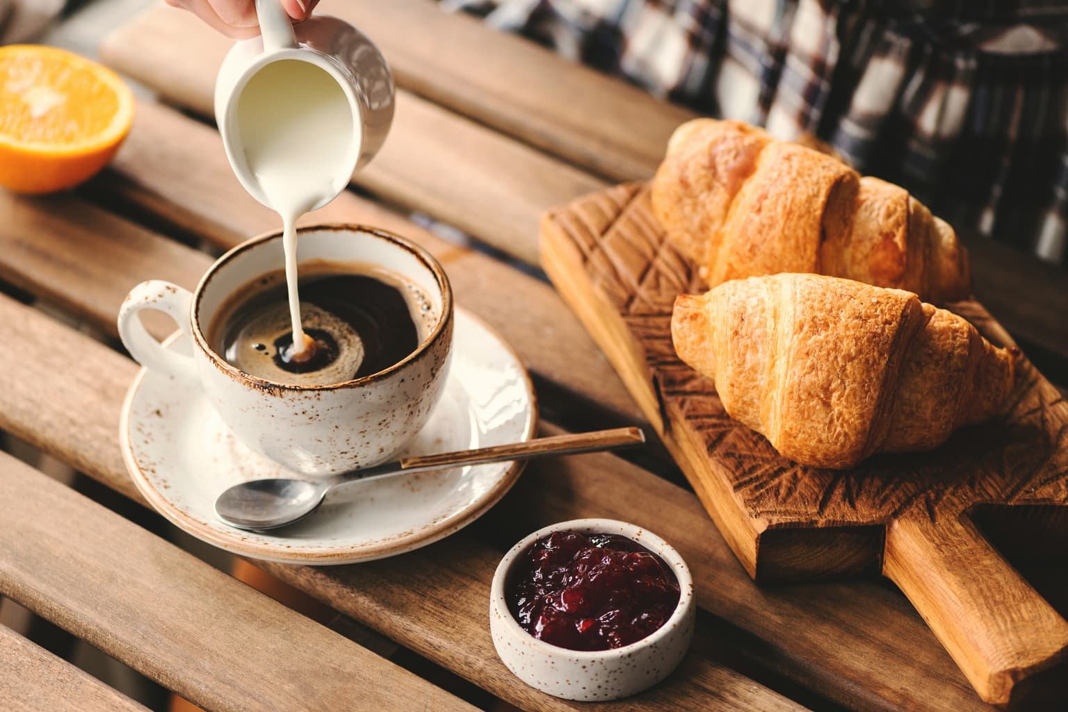 Pouring milk in coffee