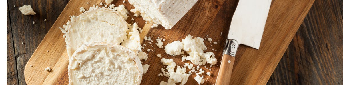 Goat cheese on cutting board