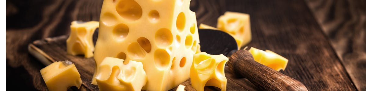 swiss cheese on cutting board